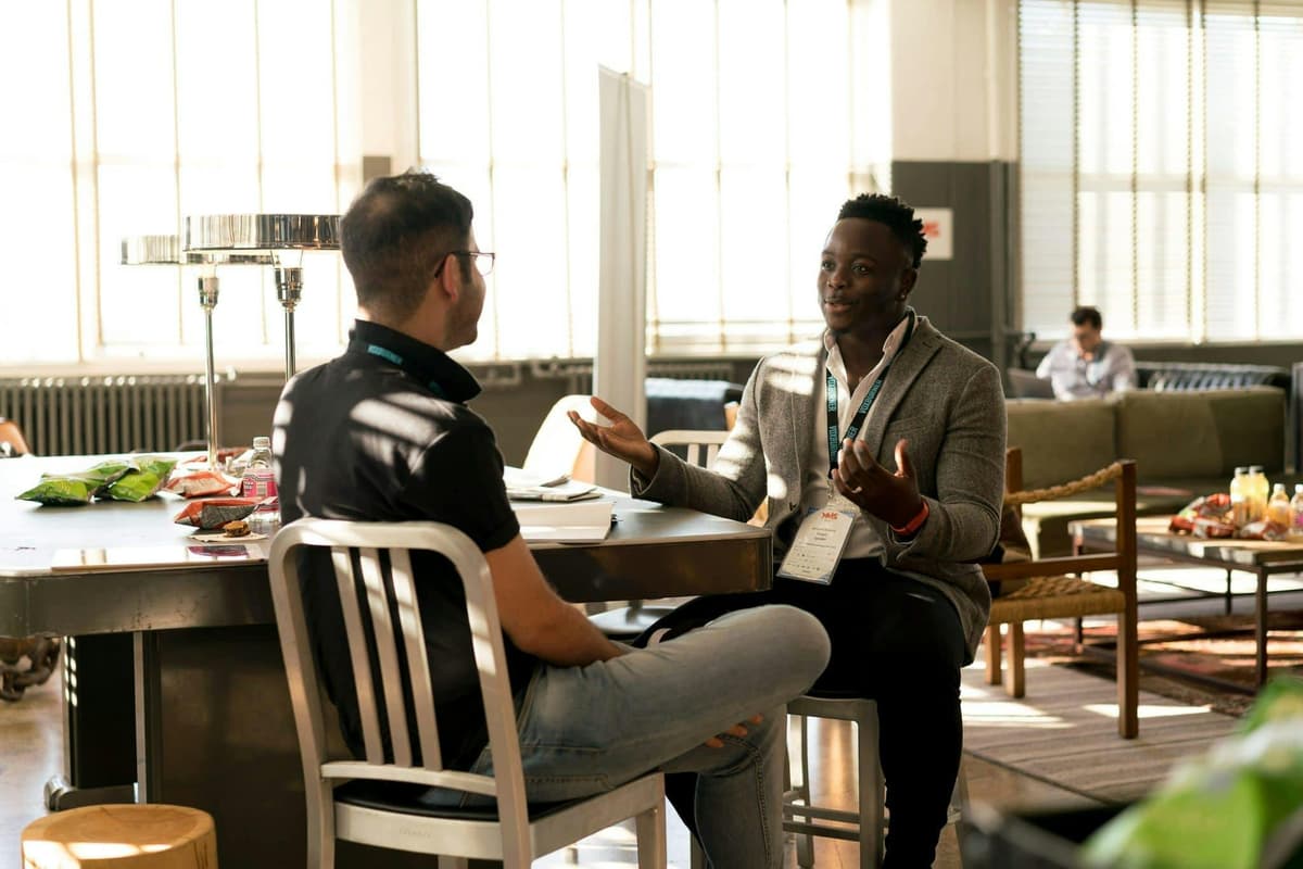 Business professionals discussing IT strategy on laptop